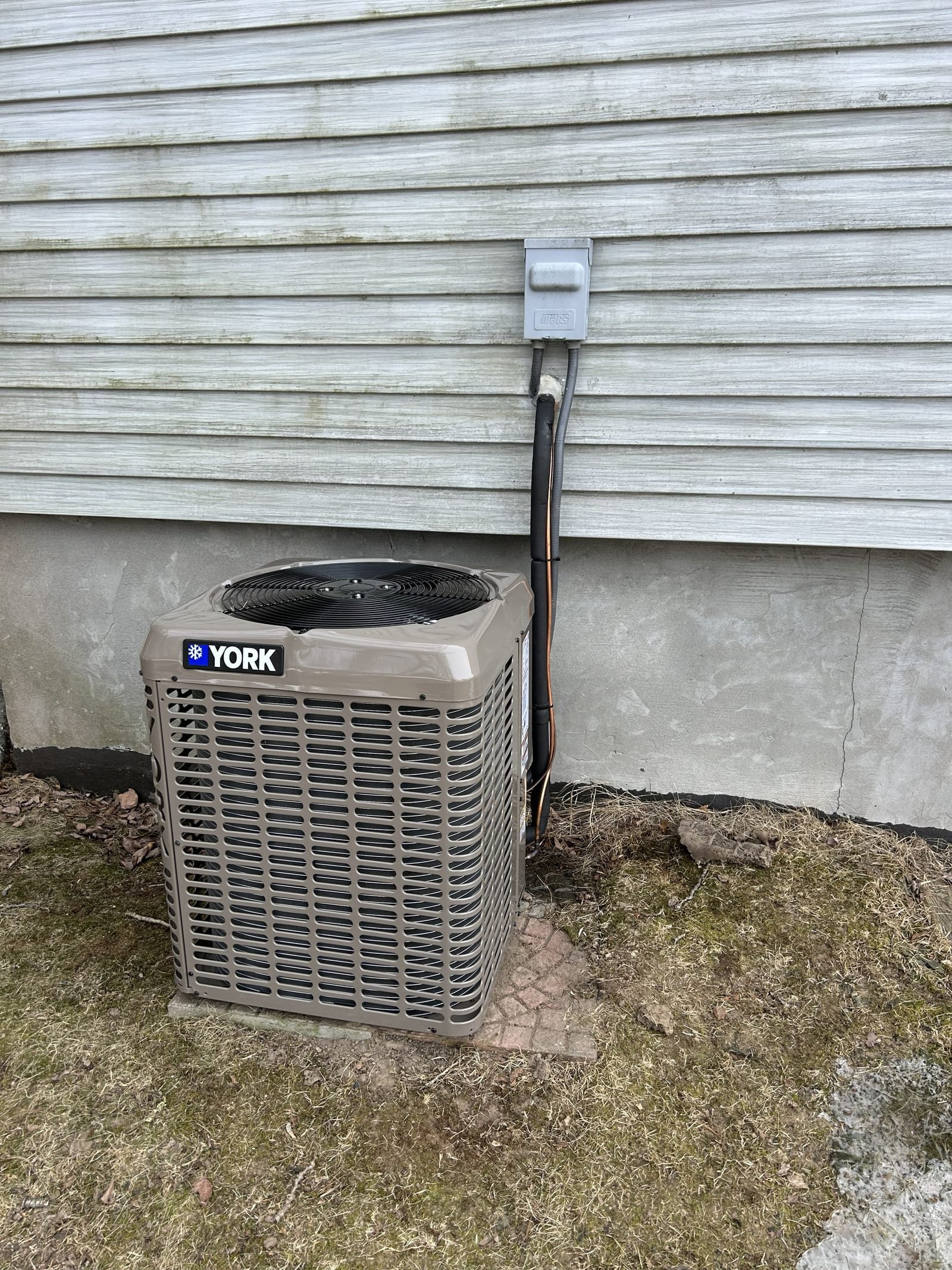 York outdoor condenser installed beside a home