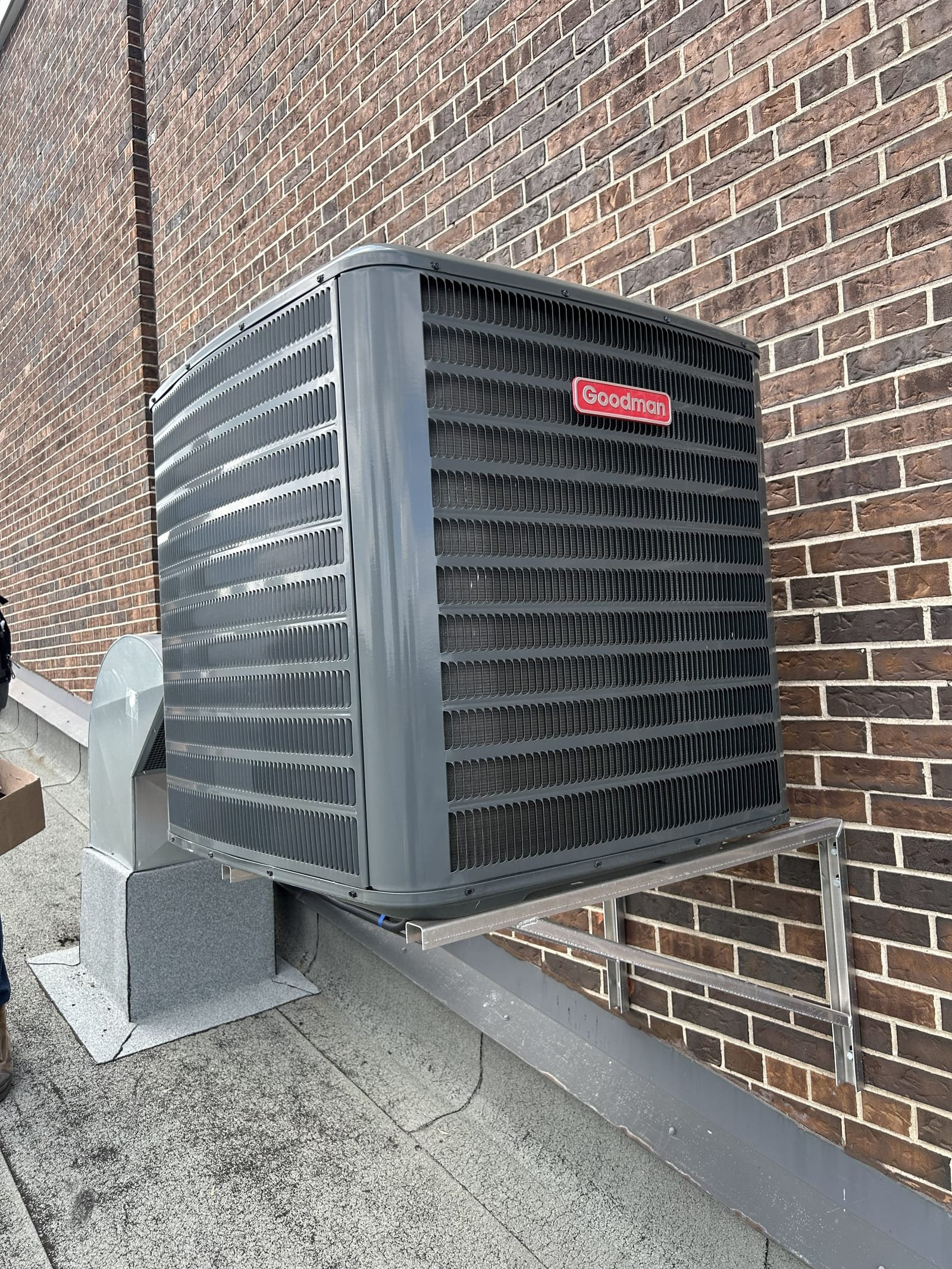 Goodman outdoor condenser on a rooftop support